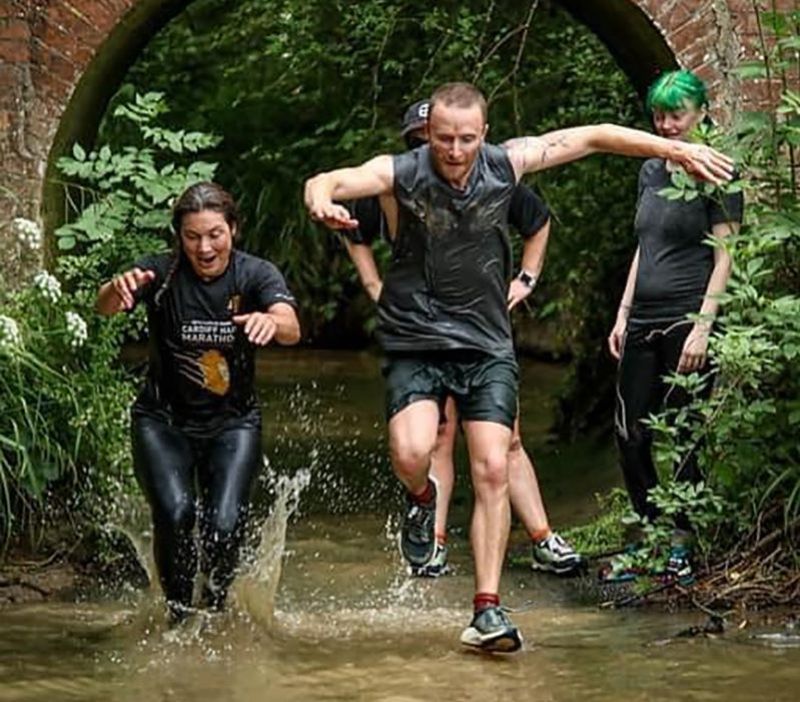 a group of people running through a river